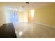 An airy living room featuring light wood floors, ample natural light from large windows, and neutral wall paint at 2118 Ne Coachman Rd, Clearwater, FL 33765