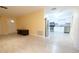 Open-concept living space showcases a seamless transition to the modern kitchen with stainless steel appliances and white cabinetry at 2118 Ne Coachman Rd, Clearwater, FL 33765