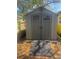 Backyard featuring a shed with a ramp and decorative doors at 2118 Ne Coachman Rd, Clearwater, FL 33765