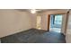 Spacious bedroom featuring neutral walls, ceiling fan, and a bathroom entrance at 2402 Ecuadorian Way # 20, Clearwater, FL 33763