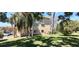 Exterior view of a building with well-maintained lawn and shade trees at 2402 Ecuadorian Way # 20, Clearwater, FL 33763