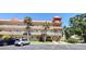 Multi-story condo building with unique architectural details, parking and manicured landscaping at 2402 Ecuadorian Way # 20, Clearwater, FL 33763