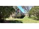 A side exterior view showcases well-maintained landscaping surrounding the building at 2402 Ecuadorian Way # 20, Clearwater, FL 33763