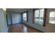 Sunlit living space offering hardwood flooring, big windows, and closet for storage at 2402 Ecuadorian Way # 20, Clearwater, FL 33763