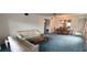 Spacious living room with carpeting, a ceiling fan, and large mirror above the dining area at 2402 Ecuadorian Way # 20, Clearwater, FL 33763