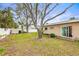 A spacious backyard features a large yard and mature trees at 2490 E Vina Del Mar Blvd, St Pete Beach, FL 33706