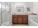 Bathroom with a glass block shower, vanity with wood cabinets, and neutral walls at 2490 E Vina Del Mar Blvd, St Pete Beach, FL 33706