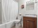 Cozy bathroom with a shower-tub combination, neutral walls, and wood vanity at 2490 E Vina Del Mar Blvd, St Pete Beach, FL 33706