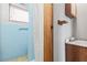 This bathroom includes a white shower curtain, a mirror, and a blue tiled shower at 2490 E Vina Del Mar Blvd, St Pete Beach, FL 33706