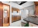 This cozy kitchen has wood cabinets, a white refrigerator, and lots of natural light at 2490 E Vina Del Mar Blvd, St Pete Beach, FL 33706
