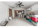 Spacious living room features tile floors, ceiling fan, and kitchenette area with breakfast bar at 2490 E Vina Del Mar Blvd, St Pete Beach, FL 33706
