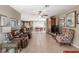 Spacious living room flowing into the dining area, featuring tile flooring and a ceiling fan at 2490 E Vina Del Mar Blvd, St Pete Beach, FL 33706