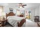 Bright main bedroom with a large bed, wooden furniture, and a sliding glass door to the backyard at 2490 E Vina Del Mar Blvd, St Pete Beach, FL 33706