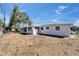 Spacious backyard featuring a gravel area, some trees, and perimeter fencing at 2533 Limewood Dr, Holiday, FL 34690
