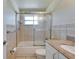 Bathroom features a bathtub and shower combination with a cultured marble double sink at 2533 Limewood Dr, Holiday, FL 34690
