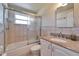 Bathroom features a bathtub and shower combination with a cultured marble sink at 2533 Limewood Dr, Holiday, FL 34690