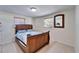 Primary bedroom featuring a queen bed, tile flooring, and neutral paint at 2533 Limewood Dr, Holiday, FL 34690
