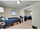 View of the bedroom with tiled floor, bed, closet, and mirror reflecting the rest of the room at 2533 Limewood Dr, Holiday, FL 34690