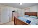 Primary bedroom featuring a queen bed, tile flooring, and neutral paint at 2533 Limewood Dr, Holiday, FL 34690