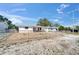 Charming single-story home with fenced yard under a bright blue sky at 2533 Limewood Dr, Holiday, FL 34690