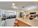 Open kitchen and living room layout with a bar, modern appliances, and lots of light at 2533 Limewood Dr, Holiday, FL 34690