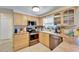 Well-lit kitchen with stainless steel appliances and light wood cabinetry at 2533 Limewood Dr, Holiday, FL 34690