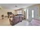 Living room with tile flooring, a large sofa, and lots of natural light at 2533 Limewood Dr, Holiday, FL 34690