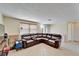 Spacious living room with tile floor and a large leather sectional sofa at 2533 Limewood Dr, Holiday, FL 34690
