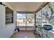 Screened patio featuring potted plants and shelving, offering a tranquil outdoor space at 2533 Limewood Dr, Holiday, FL 34690