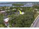 An aerial view shows close proximity to the bay with mature trees, and ample parking at 2700 Bayshore Blvd # 588, Dunedin, FL 34698