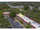 An aerial view of the apartments shows ample parking, mature trees, and easy access at 2700 Bayshore Blvd # 588, Dunedin, FL 34698