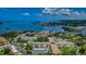 This aerial shot showcases Mediterranean Manors complex with stunning waterfront views and lush landscaping at 2700 Bayshore Blvd # 588, Dunedin, FL 34698