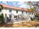 A backyard showcasing an outdoor living space with a patio, seating, and a view of the home's exterior at 2700 Bayshore Blvd # 588, Dunedin, FL 34698