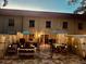 An illuminated backyard patio at dusk with seating, dining, and decorative lighting creating an inviting outdoor space at 2700 Bayshore Blvd # 588, Dunedin, FL 34698