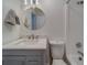 Cozy bathroom with round mirror, shower/tub combo, and modern vanity at 2700 Bayshore Blvd # 588, Dunedin, FL 34698