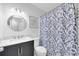 Stylish bathroom with a modern vanity, framed mirror, and blue floral shower curtain at 2700 Bayshore Blvd # 588, Dunedin, FL 34698