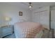 Bedroom featuring wood-look floors, modern ceiling fan, and closet with louvered doors at 2700 Bayshore Blvd # 588, Dunedin, FL 34698