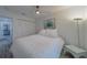 Bedroom with wood-look floors, ceiling fan and a bench in view of the closet at 2700 Bayshore Blvd # 588, Dunedin, FL 34698