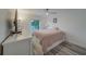 Bright bedroom featuring wood floors, white trim, ceiling fan and a large window at 2700 Bayshore Blvd # 588, Dunedin, FL 34698