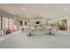 Bright community center with tables, chairs, piano, and windows, ideal for events at 2700 Bayshore Blvd # 588, Dunedin, FL 34698