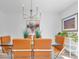 Bright dining room featuring a glass table with orange chairs and modern light fixture at 2700 Bayshore Blvd # 588, Dunedin, FL 34698