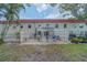 Rear exterior view of townhomes with fenced patios and well-maintained landscaping at 2700 Bayshore Blvd # 588, Dunedin, FL 34698