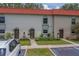 Exterior of townhomes featuring well maintained lawns and designated parking spaces at 2700 Bayshore Blvd # 588, Dunedin, FL 34698