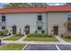 Front exterior of townhomes with lush landscaping and convenient parking at 2700 Bayshore Blvd # 588, Dunedin, FL 34698