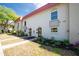 Charming townhome exterior with well-maintained landscaping, walkways, and inviting entryways under a blue sky at 2700 Bayshore Blvd # 588, Dunedin, FL 34698