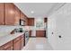 Bright kitchen with stainless steel appliances, hardwood cabinets, and white tiled floor at 2700 Bayshore Blvd # 588, Dunedin, FL 34698