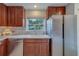 Bright kitchen showcasing stainless steel dishwasher and refrigerator at 2700 Bayshore Blvd # 588, Dunedin, FL 34698