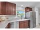 Well-lit kitchen featuring stainless steel appliances and warm hardwood cabinets at 2700 Bayshore Blvd # 588, Dunedin, FL 34698