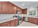 Charming kitchen with stainless steel appliances, hardwood cabinets, and white backsplash at 2700 Bayshore Blvd # 588, Dunedin, FL 34698
