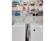 Functional laundry room featuring two washing machines and ample storage shelves at 2700 Bayshore Blvd # 588, Dunedin, FL 34698
